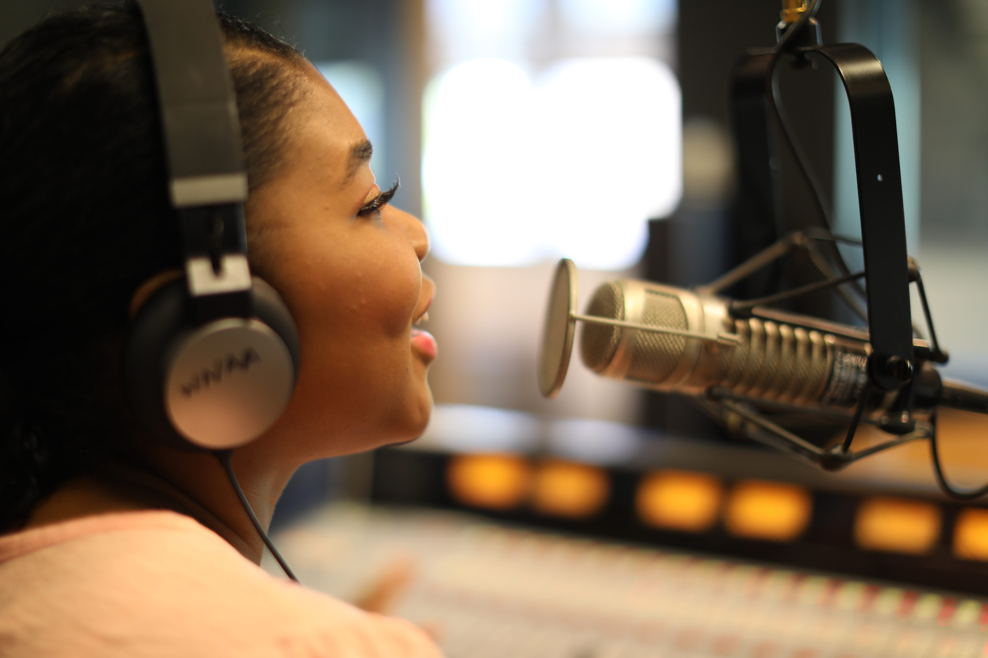 Young African American Woman Speaking into Microphone