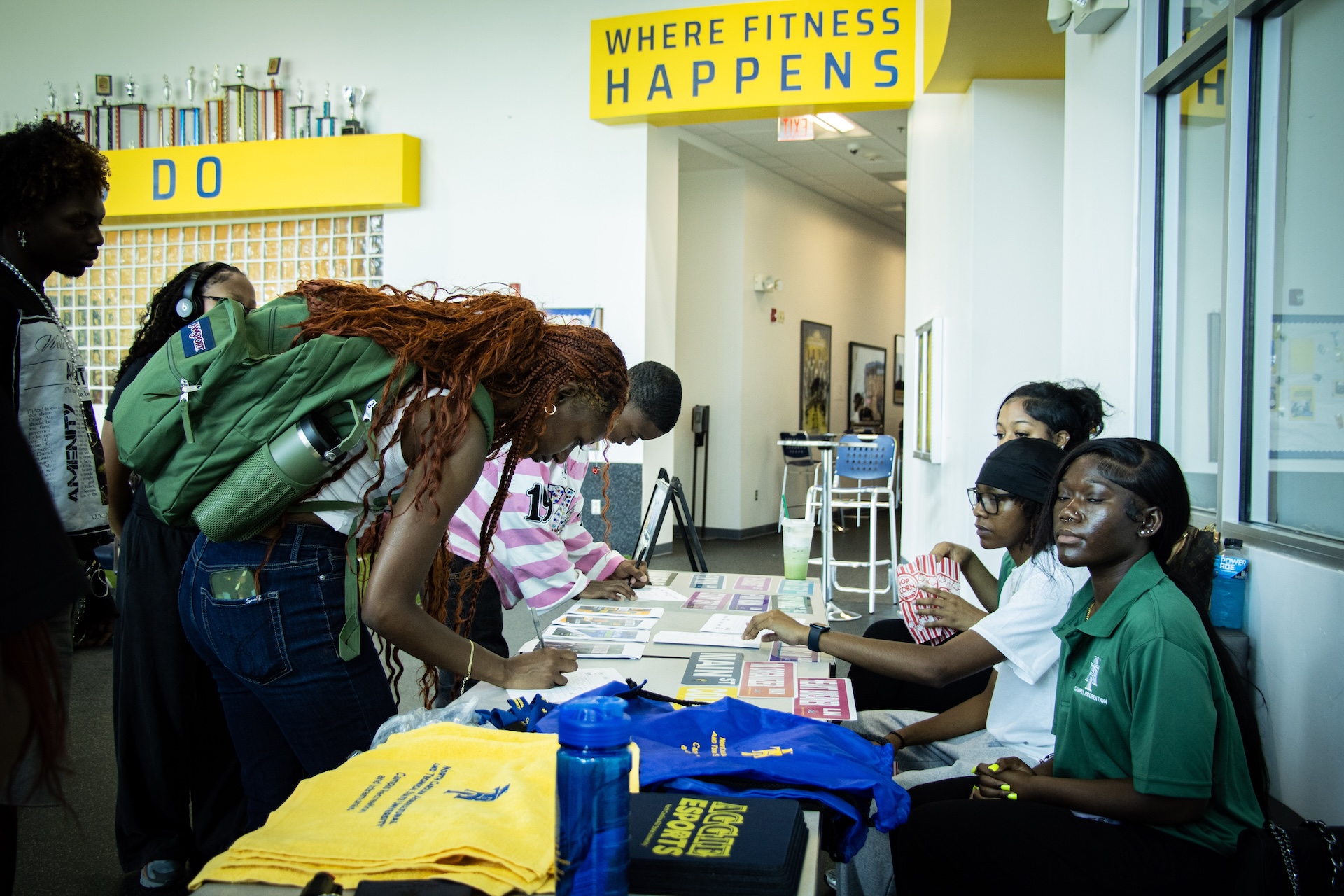 Student signing up at table for CRC's welcome week event