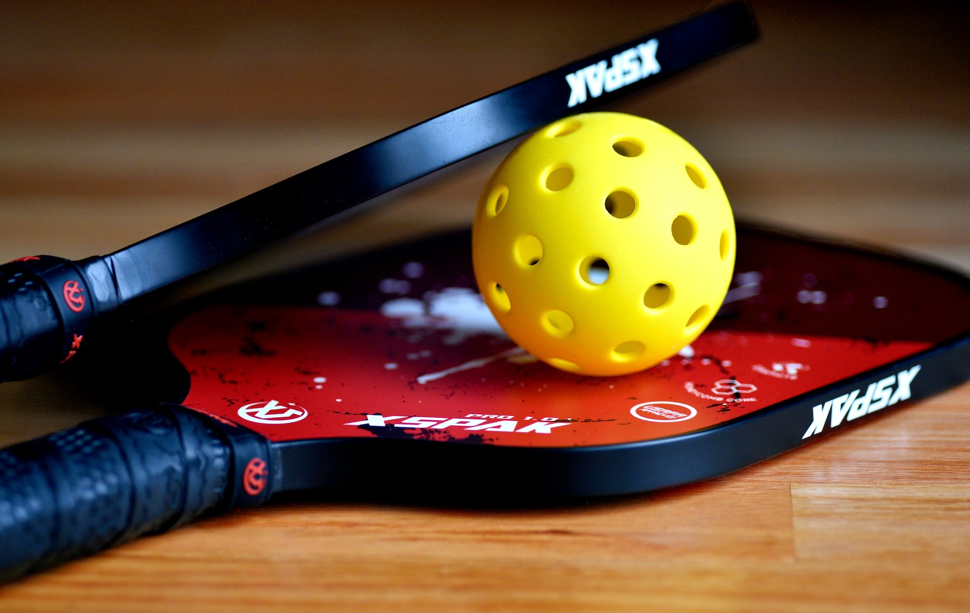 pickleball racket with pickleballs Photo by Ben Hershey on Unsplash