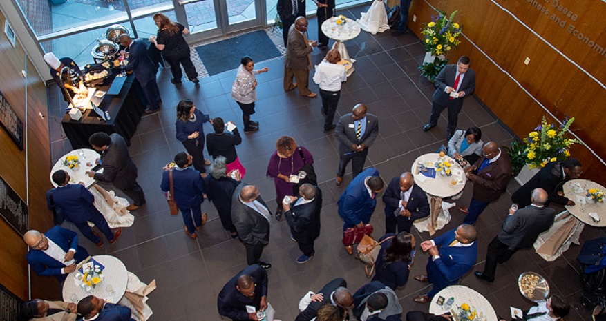 Employees standing while socializing at an event