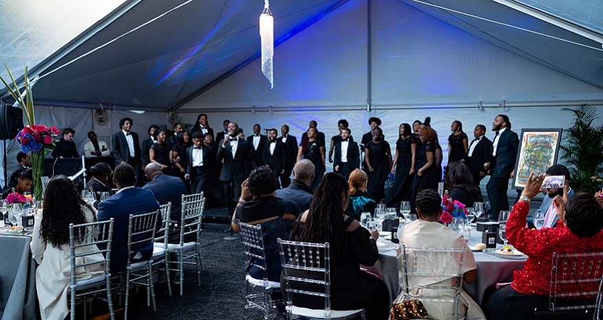 Choir sing at event outdoors under a tent