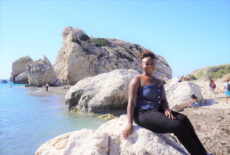 Senior Alexa Smith sitting at Aphrodite's Rock.