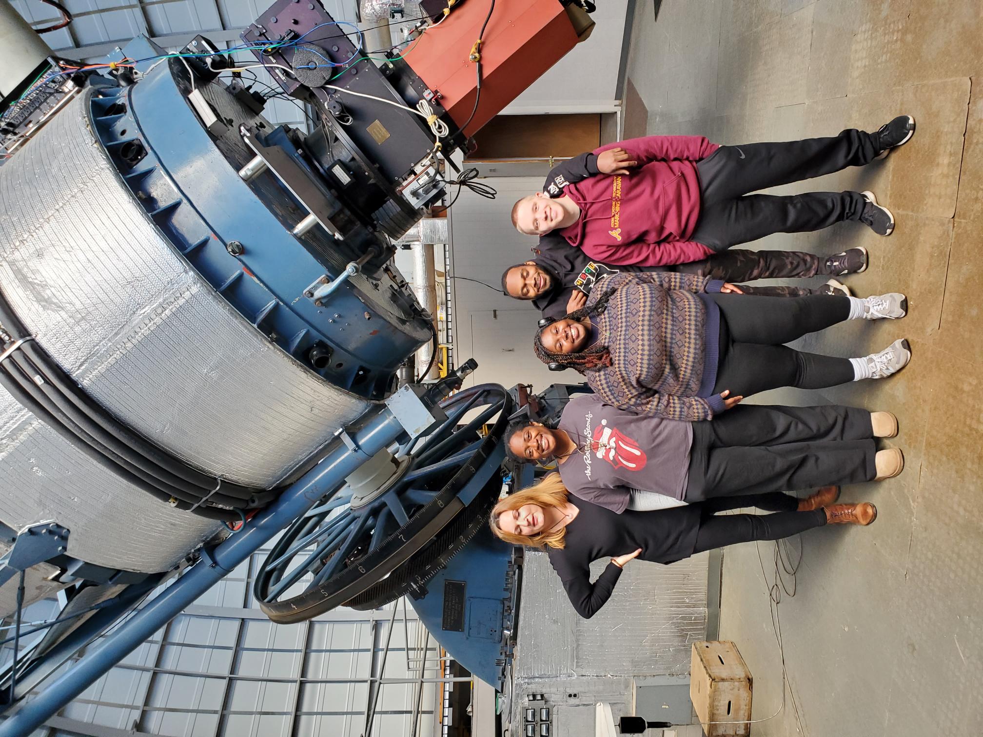 image of Athina Meli, Ph.D. and students senior Vanessa Jones. junior Madison Jordan, senior Payton Sanford and junior Bryce Badgett in front of the famous Perkins Telescope.