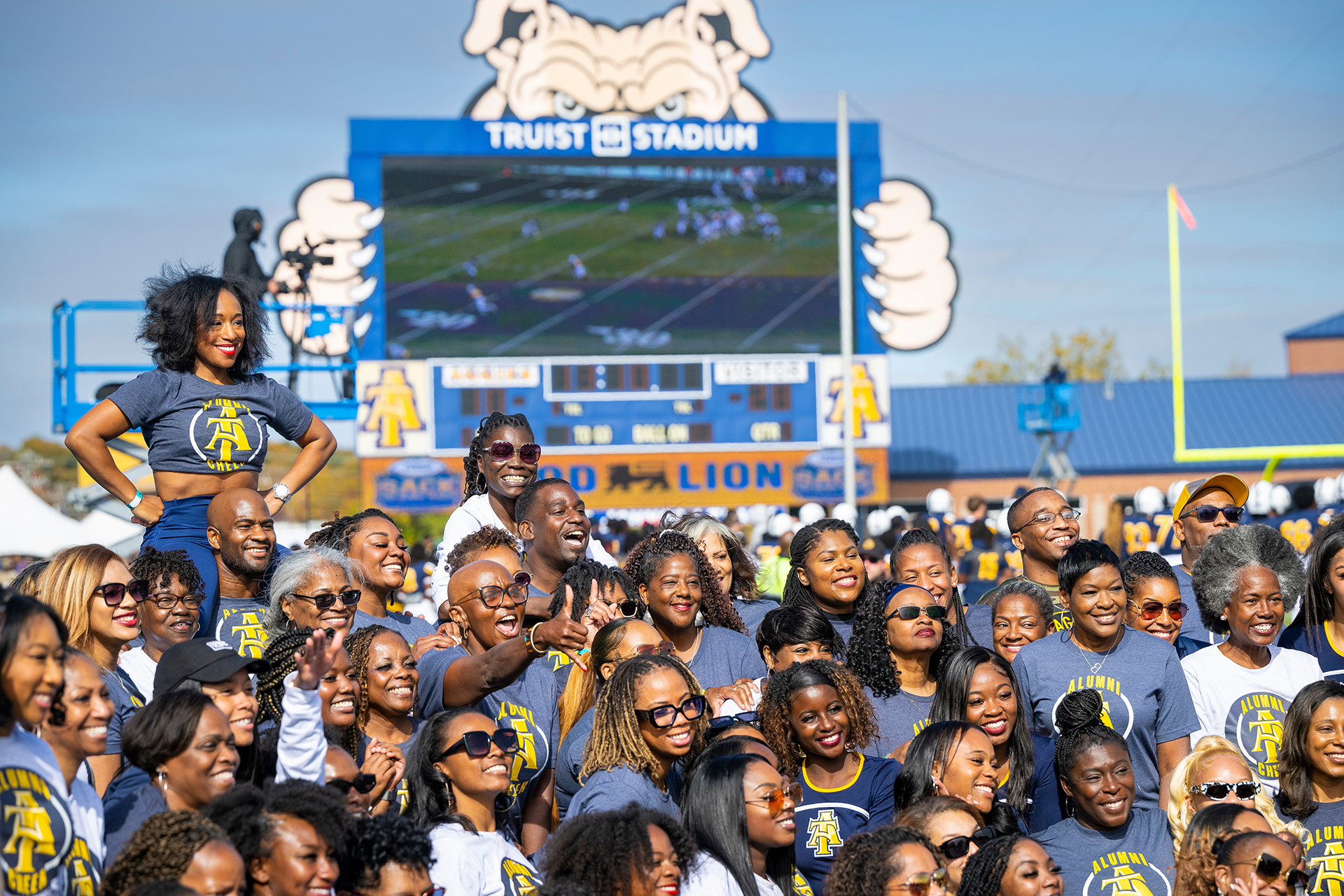 Aggie Cheer Alumni Pose for photos at Homecoming