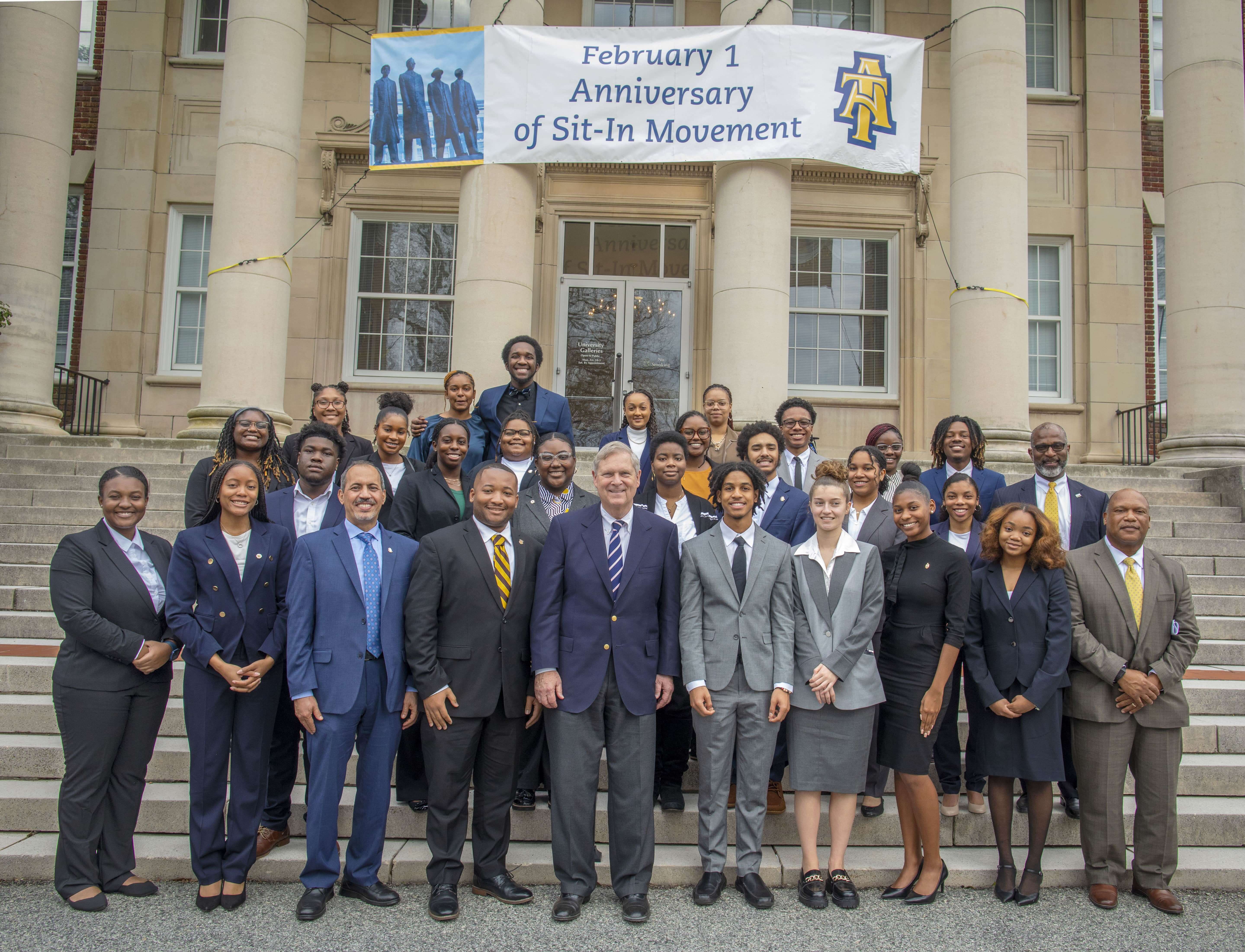 U.S. Department of Agriculture Secretary Tom Vilsack, center, and College of Agriculture and Environmental Sciences Dean Mohamed Ahmedna, third from left, pose with 26 USDA 1890s Scholars and USDA National Institute of Food and Agriculture Scholars.