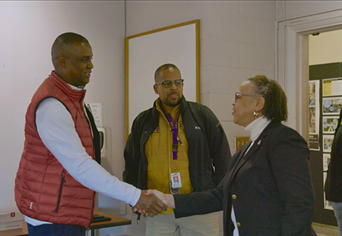 Toyota N.C. President Sean Suggs, left, is greeted by CAES Interim Dean Shirley Hymon-Parker, right, during his visit to campus to view the senior class's designs for the environmental learning trail.