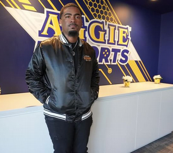 DaSean Wade Neclos Jr. stands in front of the counter at the Aggie Esports lab