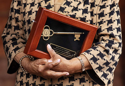 Shirley Frye holding a framed Ket to the City of Greensboro